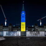 Photo of the Peace Tower lit with the colours of the Ukrainian flag